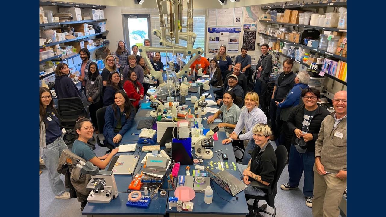 a group of people smiling in a science lab