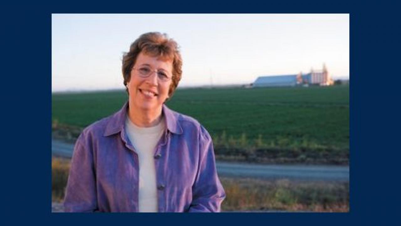 Lois Wolk in front of a farm