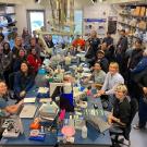 a group of people smiling in a science lab