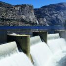 A dam with water pouring out of it.