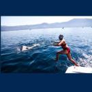 Woman jumping into water